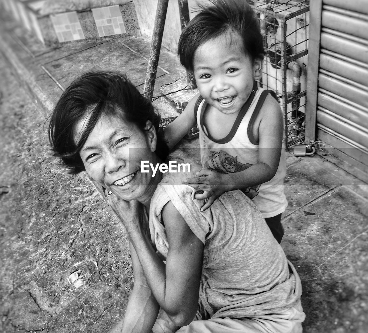 PORTRAIT OF A SMILING GIRL WITH MOTHER AND DAUGHTER