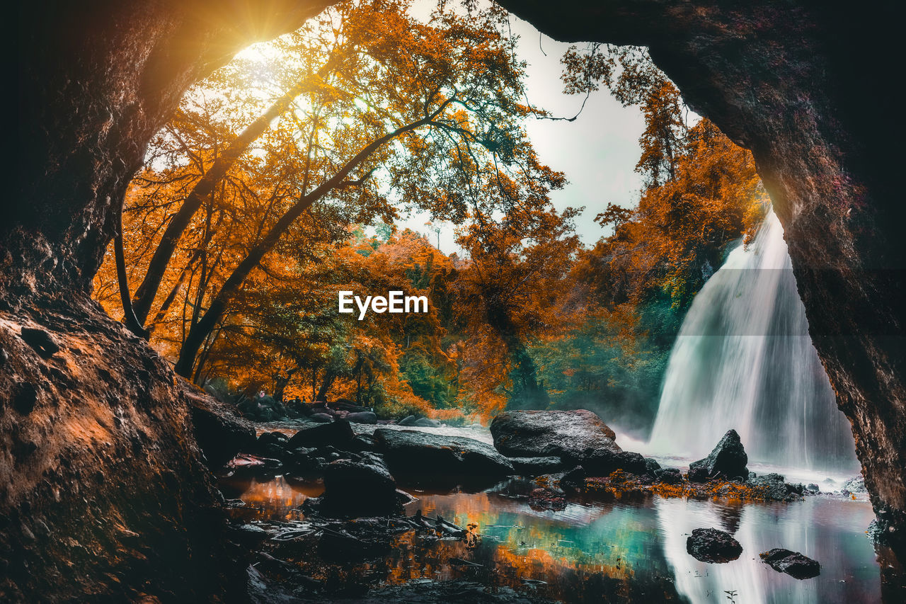 Panoramic view of waterfall in forest during autumn