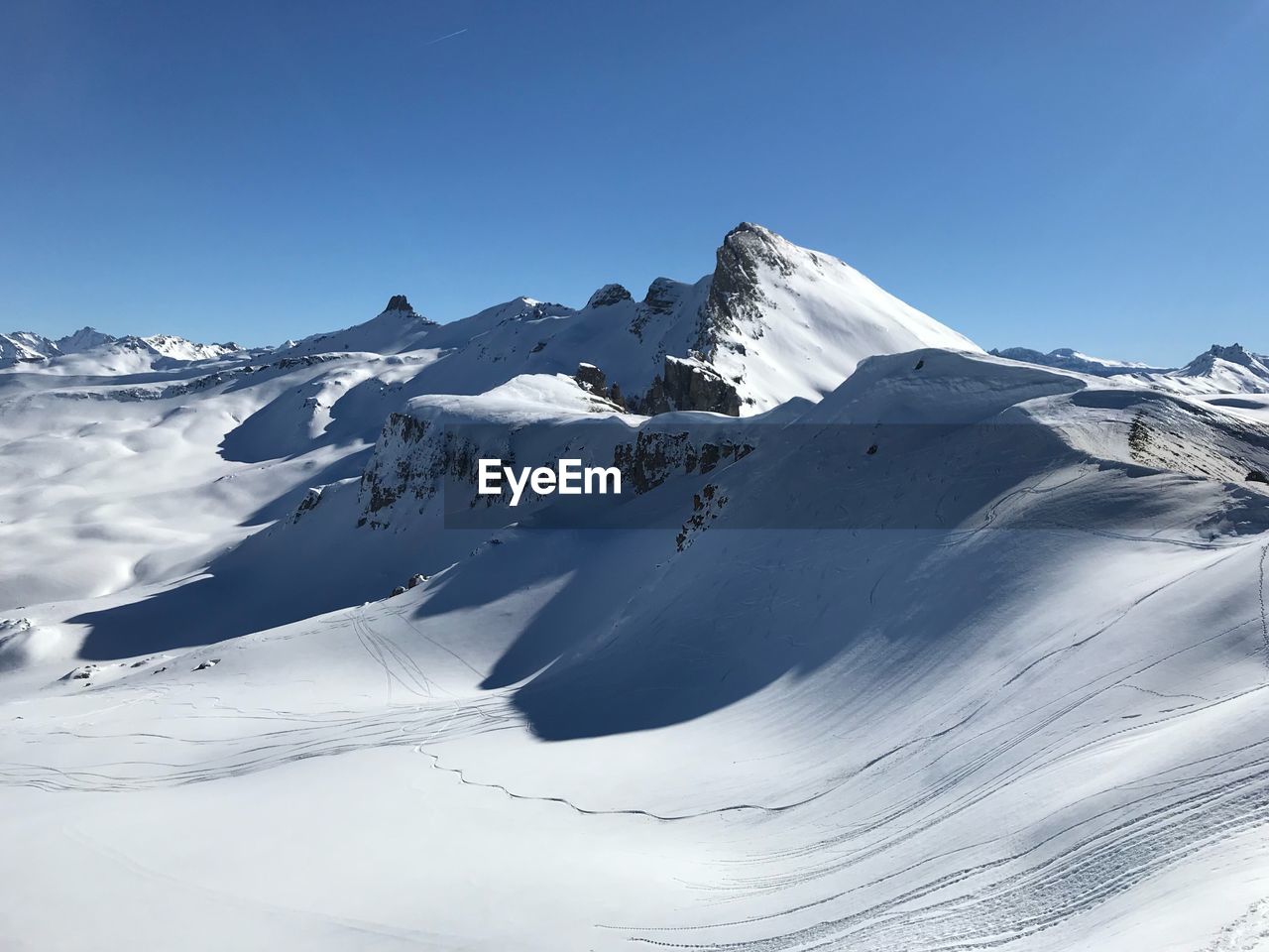 Scenic view of snowcapped mountains against clear sky