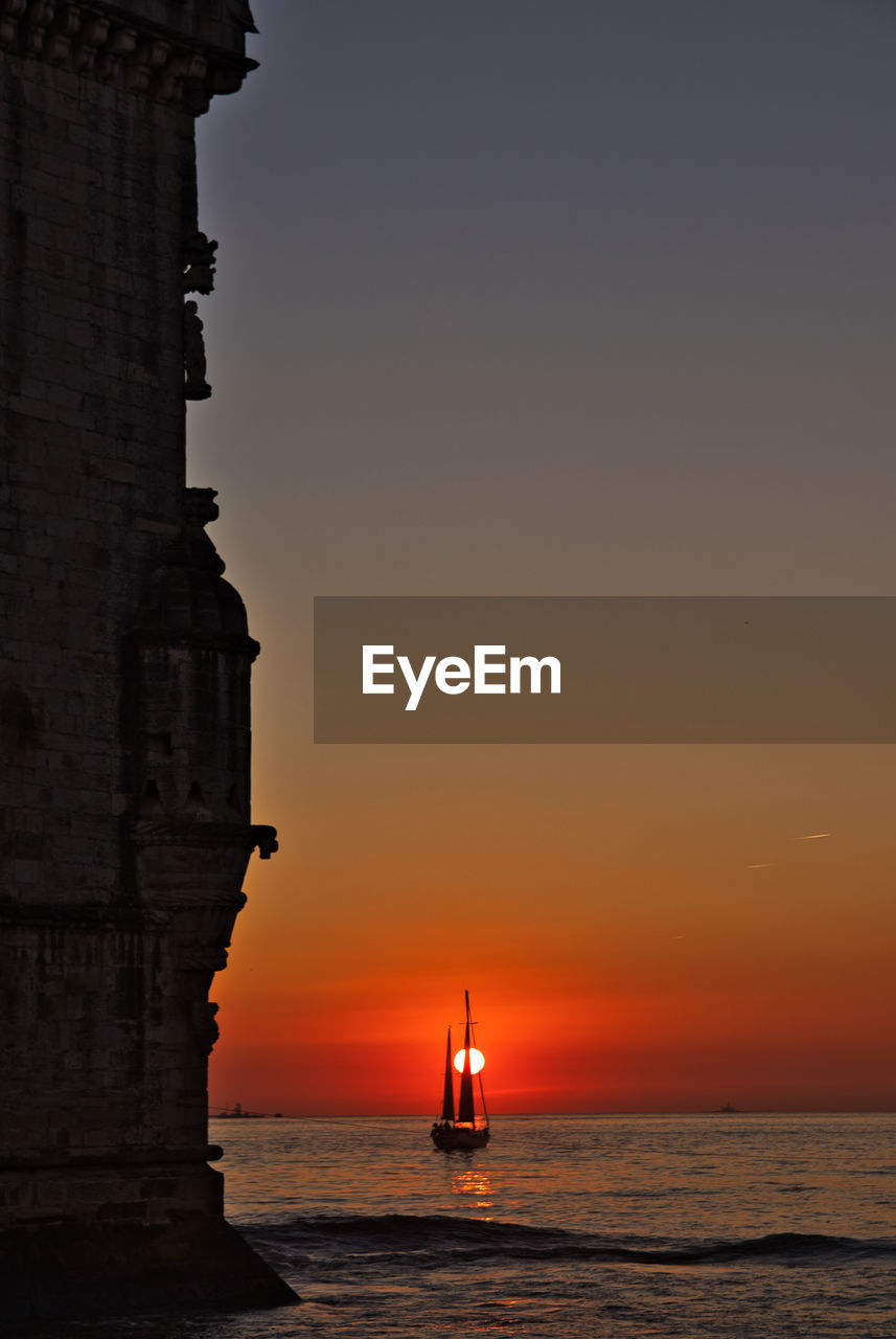 Silhouette of building against sky during sunset