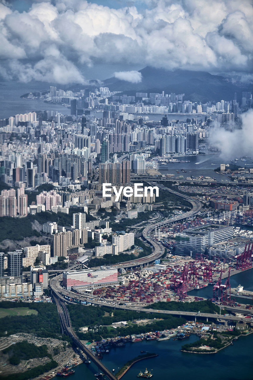 High angle view of city against cloudy sky