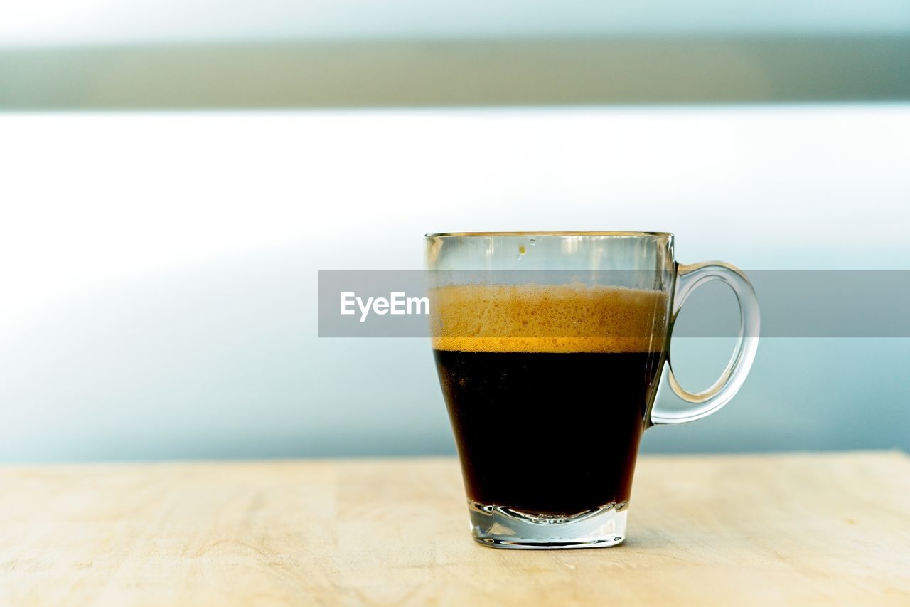CLOSE-UP OF COFFEE WITH GLASS OF TABLE