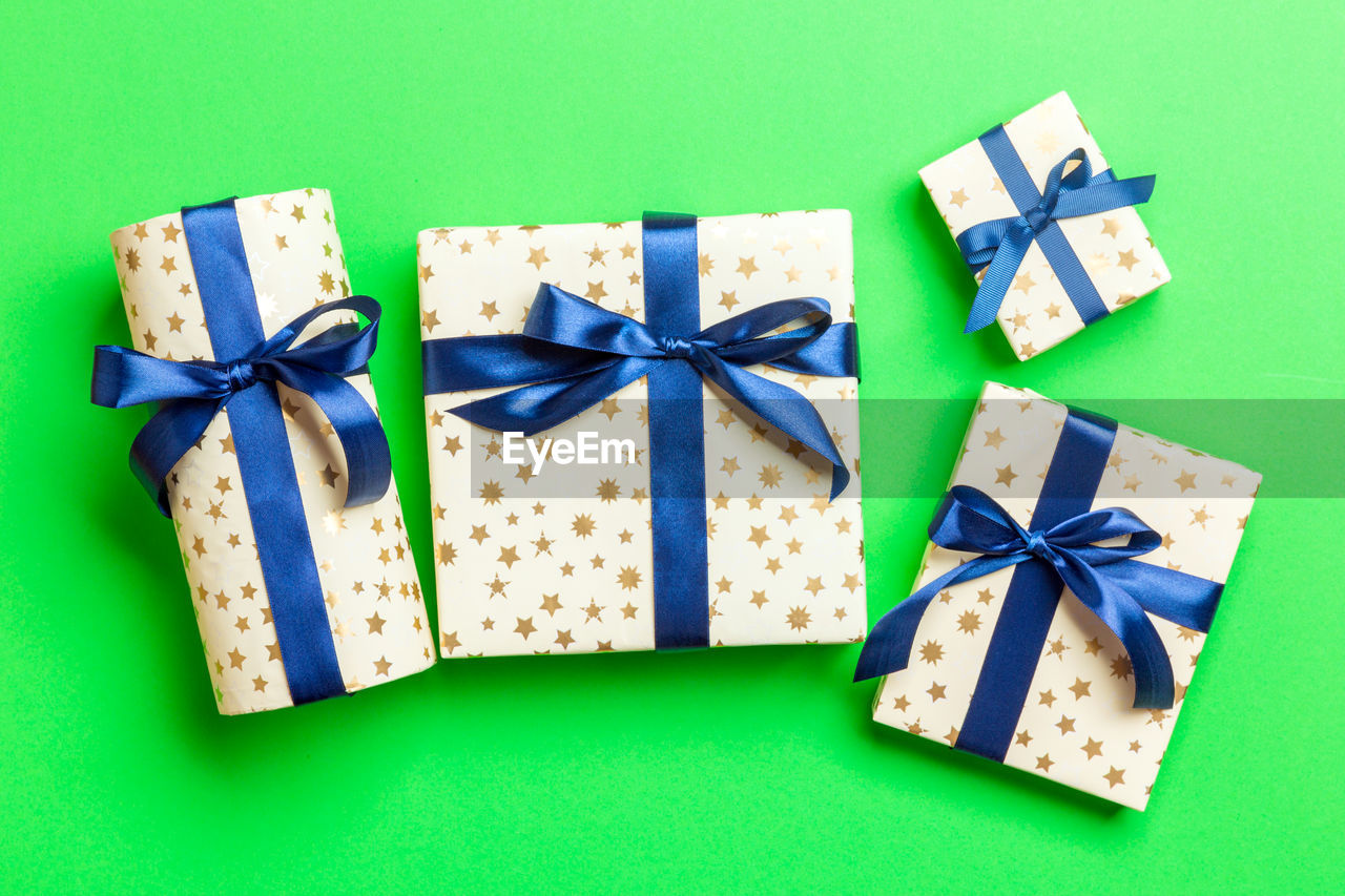 Holiday handmade present in paper on colorful background. present box on colored table, top view.