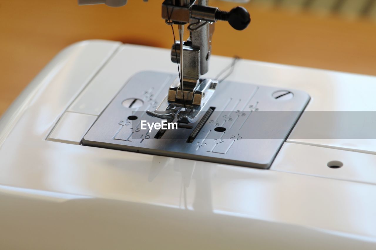Close-up of sewing machine on table