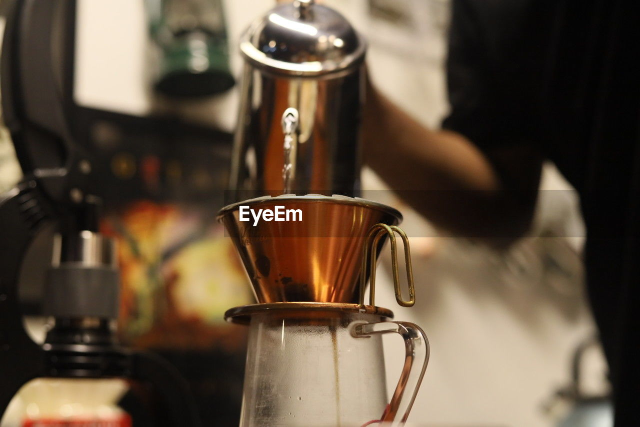 cropped hand of man holding coffee