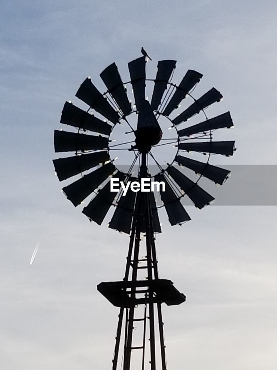 LOW ANGLE VIEW OF SILHOUETTE WINDMILLS AGAINST SKY