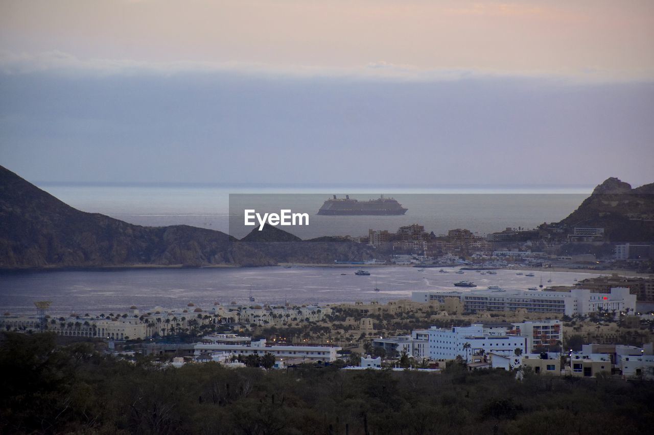 scenic view of sea and buildings against sky