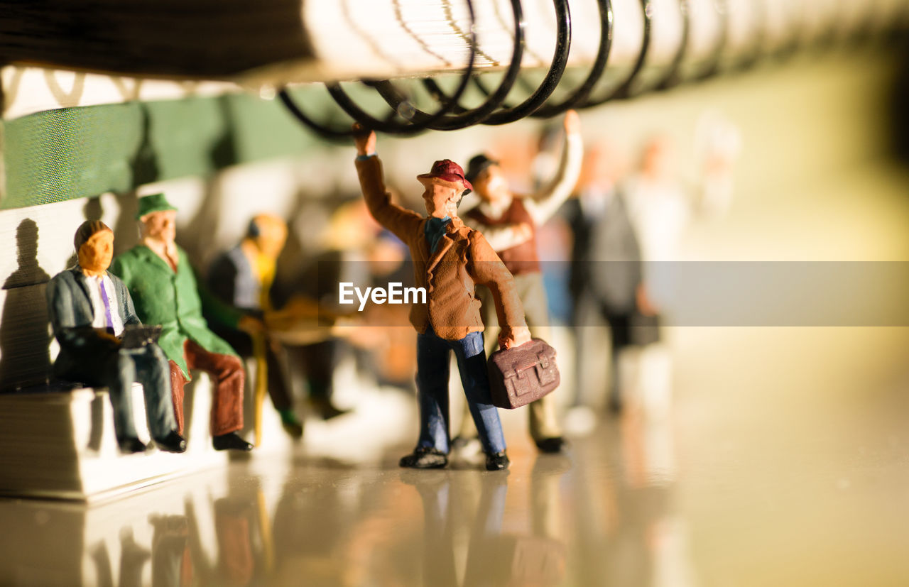 Close-up of figurines and spiral notebook on floor