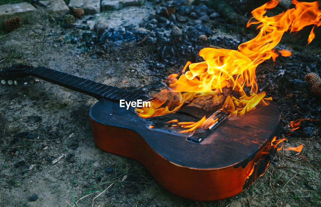 Shot of an acoustic guitar engulfed in strong flames