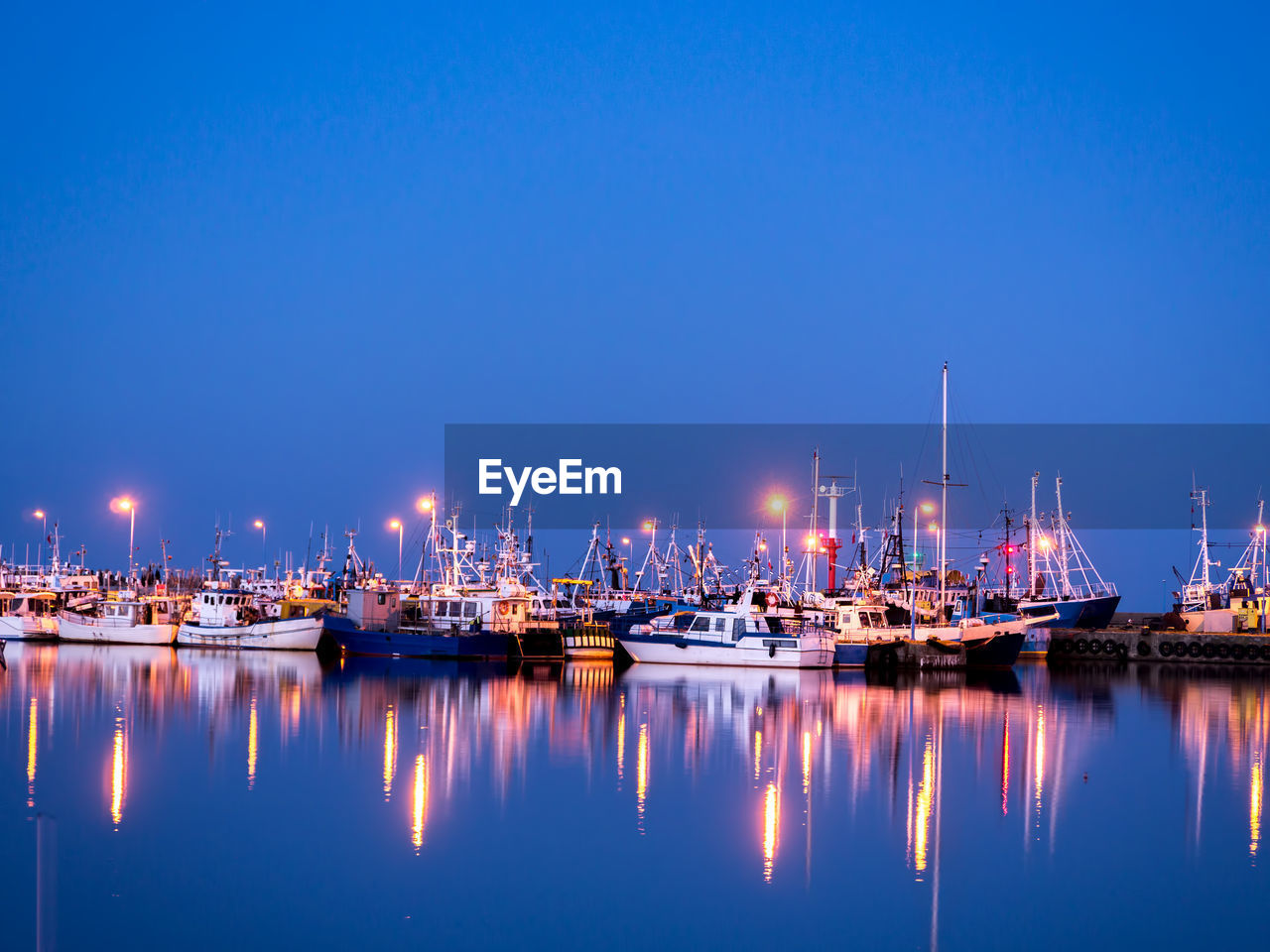 Fishing port at twilight with reflections