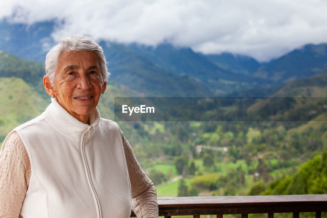 Senior woman at the beautiful view point over the cocora valley in salento in colombia