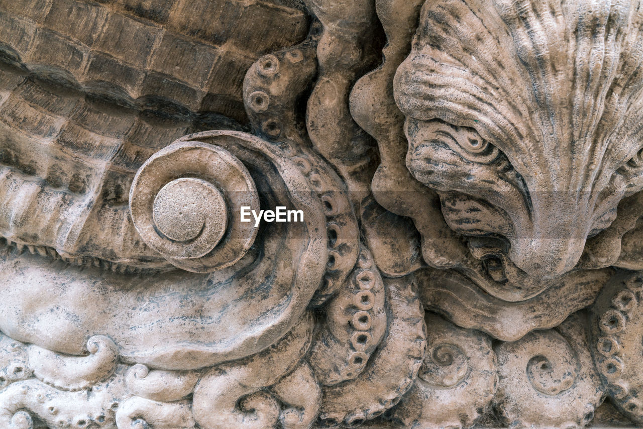 Close-up of carved stone in shape of nautical creatures