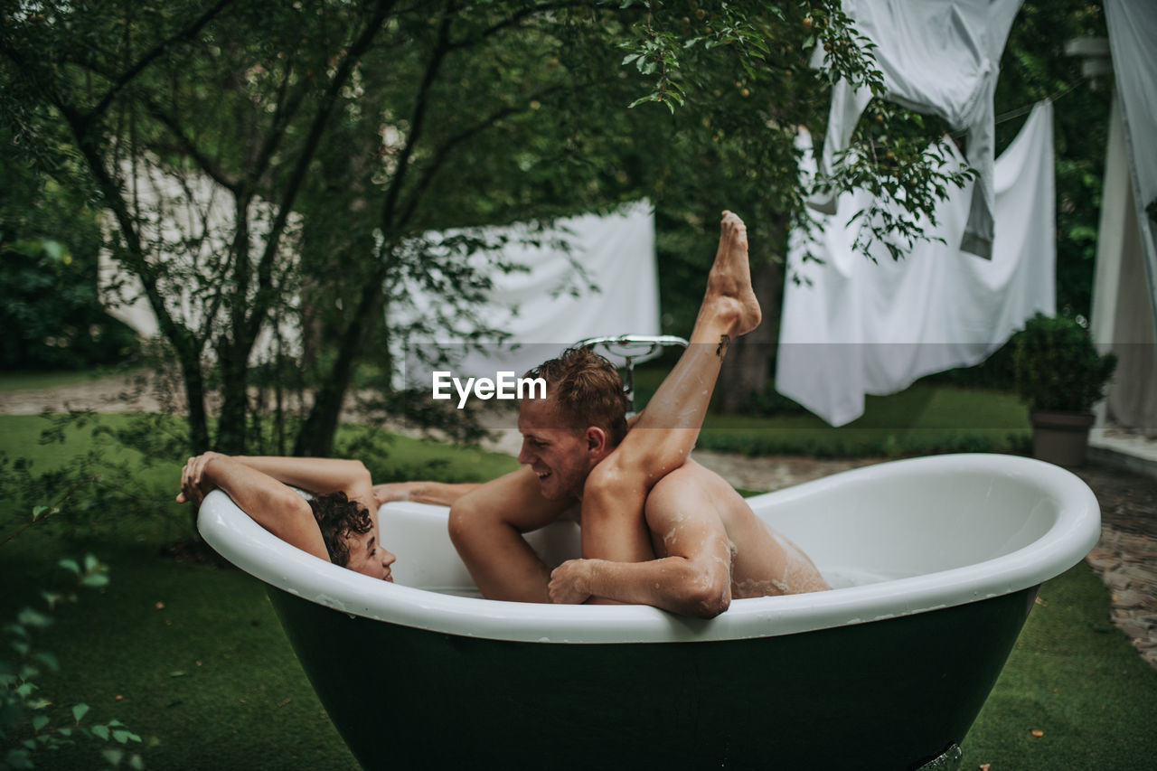 Couple in bathtub outdoors