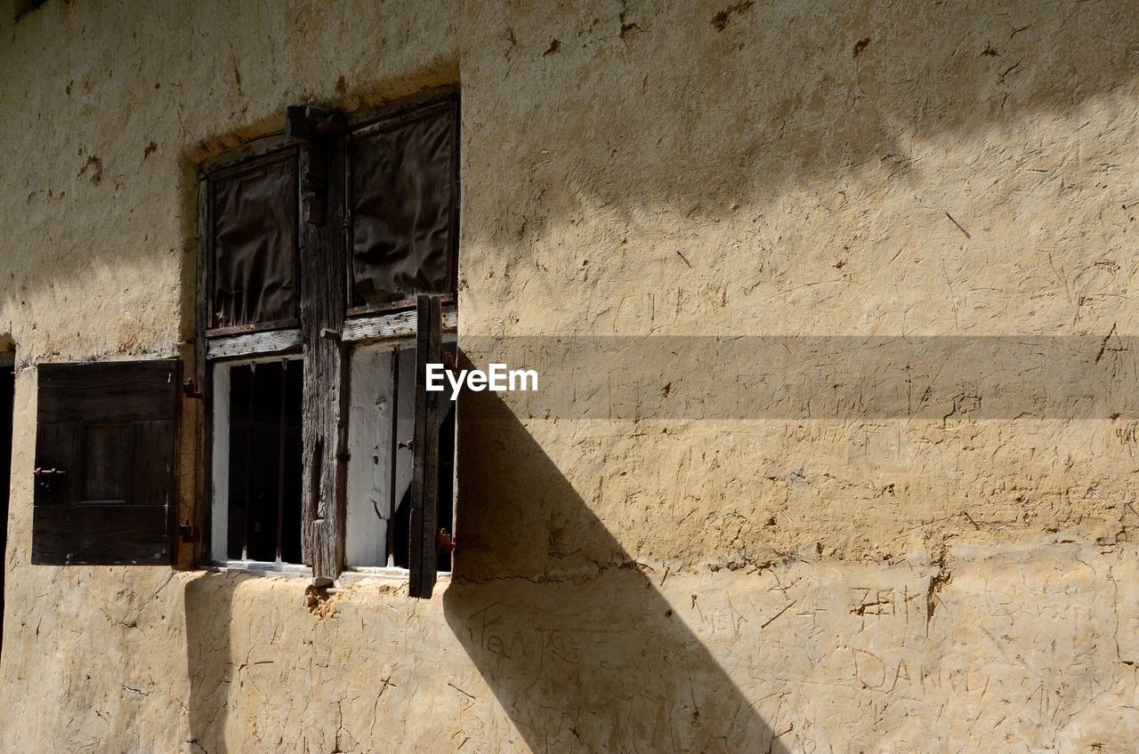 ABANDONED HOUSE AGAINST WALL