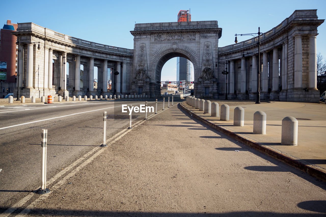 Manhattan bridge arch and colonnade on a sunny day in new york, nyc