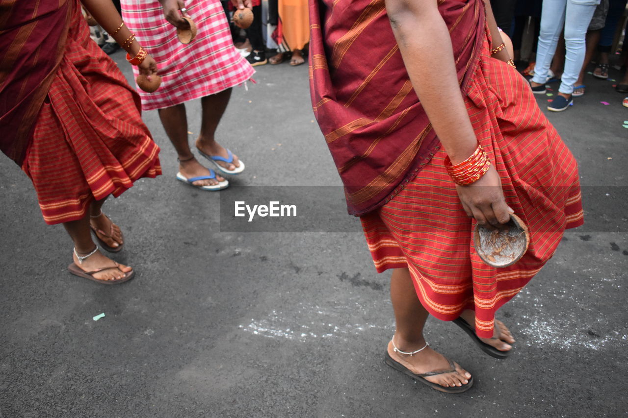 Low section of people dancing on street
