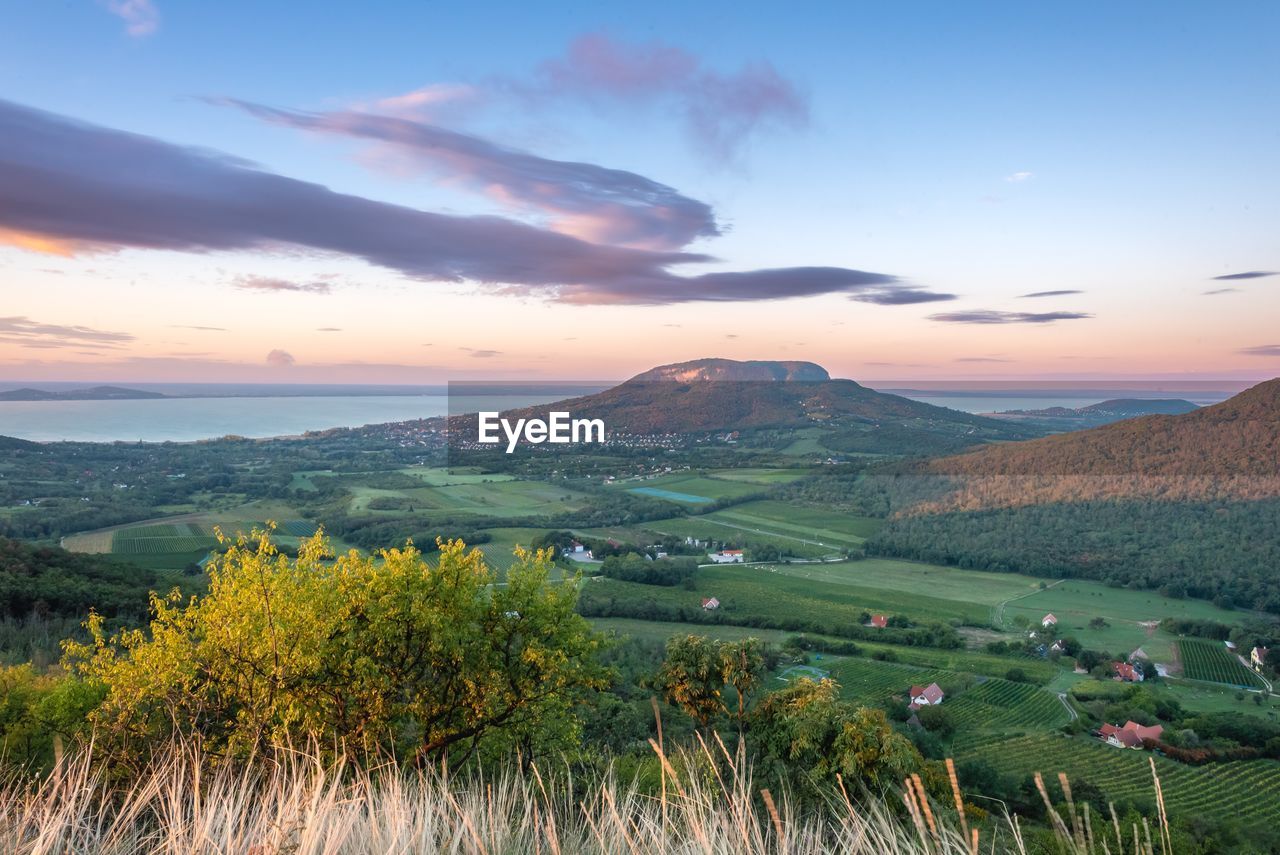 landscape, environment, sky, nature, scenics - nature, mountain, land, plant, beauty in nature, sunset, cloud, field, rural scene, grass, sun, rural area, horizon, tree, agriculture, tranquility, travel, plain, mountain range, no people, travel destinations, meadow, outdoors, tranquil scene, sunlight, architecture, valley, twilight, summer, grassland, dawn, dramatic sky, tourism, crop, non-urban scene, green, flower, building, plateau, water, blue, wilderness, environmental conservation, social issues, idyllic, multi colored, forest, springtime, farm, prairie, fog, flowering plant, autumn, growth