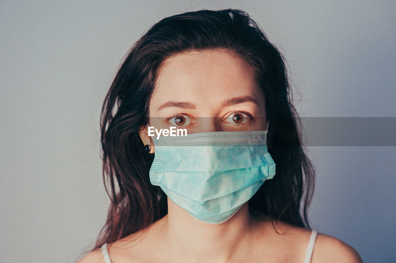 Close-up portrait of woman wearing mask