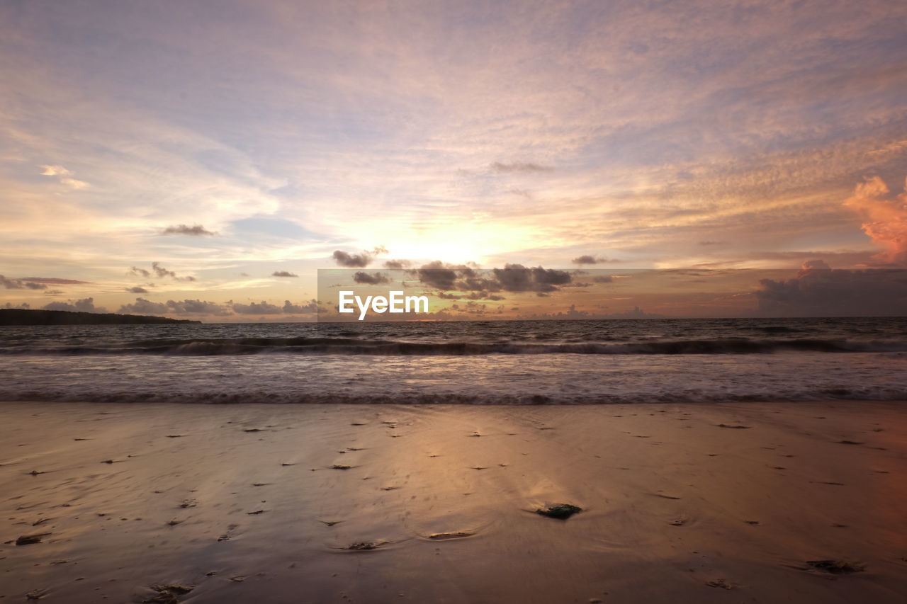 Scenic view of beach against sky during sunset