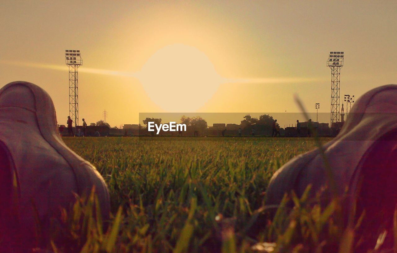 CLOSE-UP OF MAN IN FIELD AGAINST CLEAR SKY