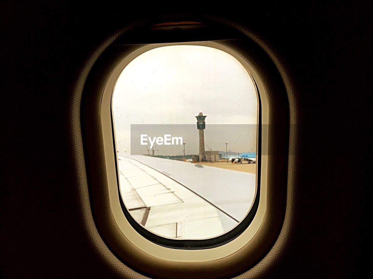 AIRPLANE WING SEEN THROUGH WINDOW OF AIRPLANE