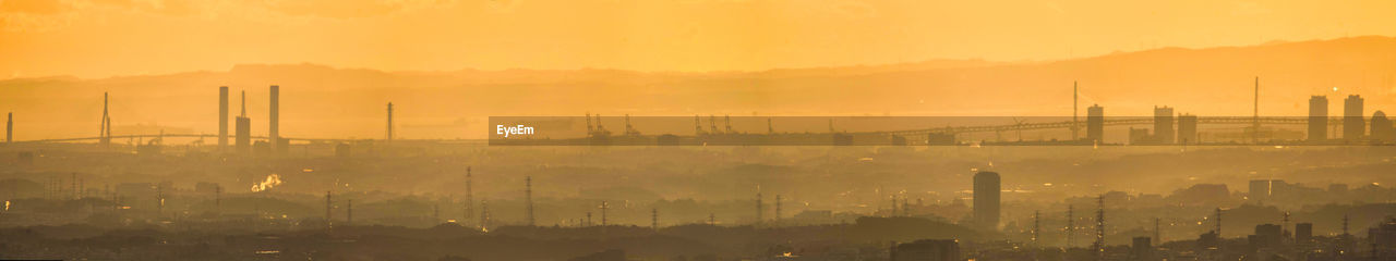 High angle view of buildings in city during sunset