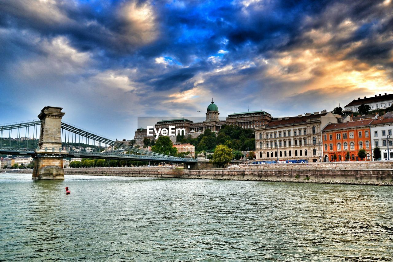 VIEW OF RIVER WITH BUILDINGS IN BACKGROUND