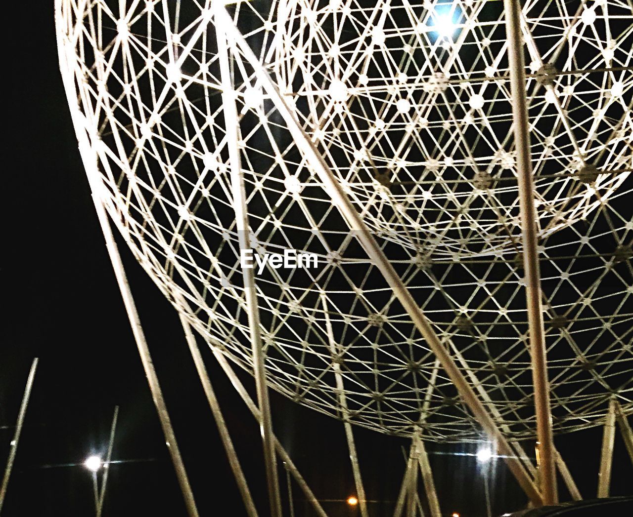 LOW ANGLE VIEW OF ILLUMINATED BUILT STRUCTURE AT NIGHT