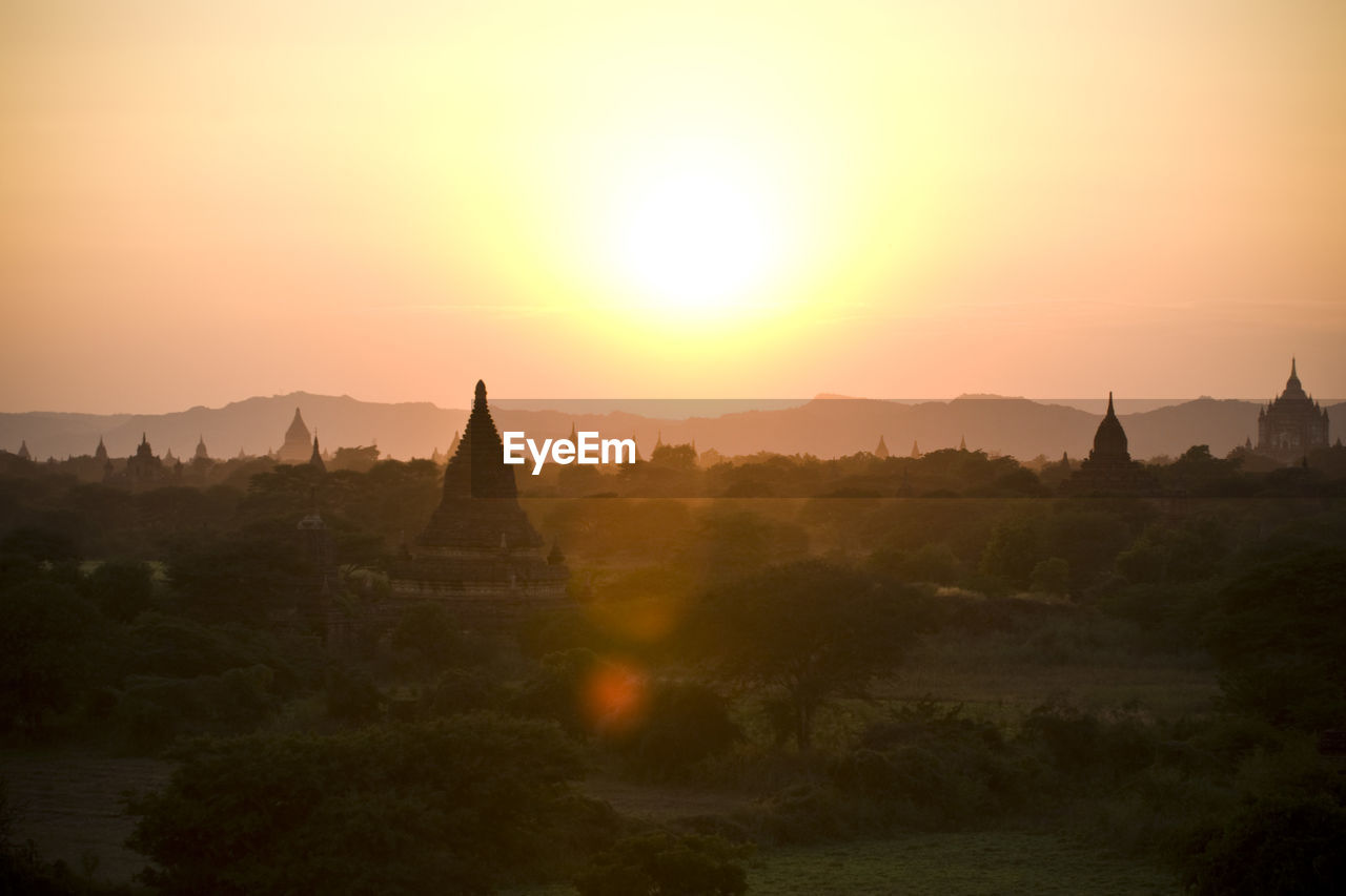 Temples against clear sky during sunset