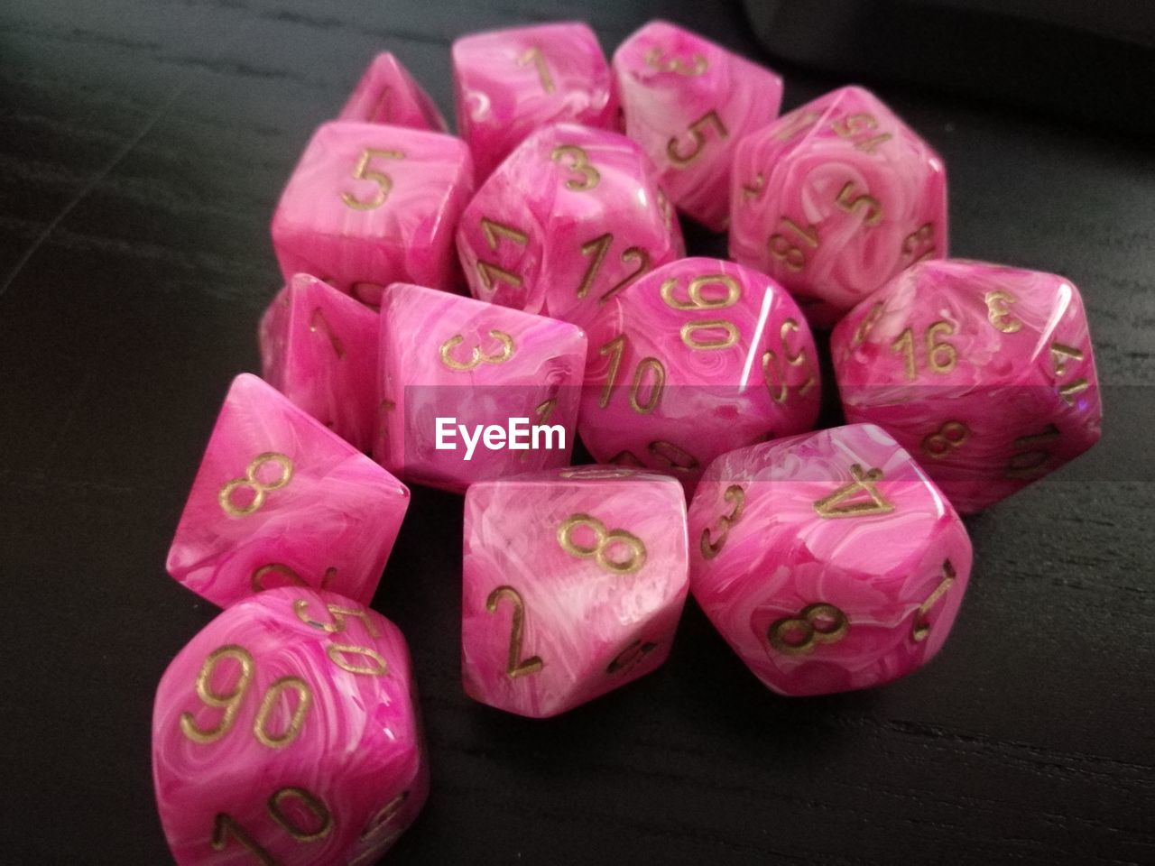 High angle view of numbers on pink dice