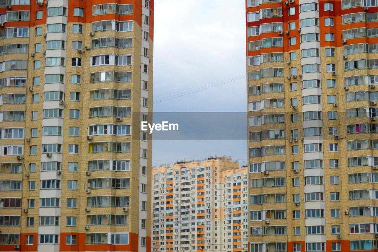 LOW ANGLE VIEW OF RESIDENTIAL BUILDINGS AGAINST SKY