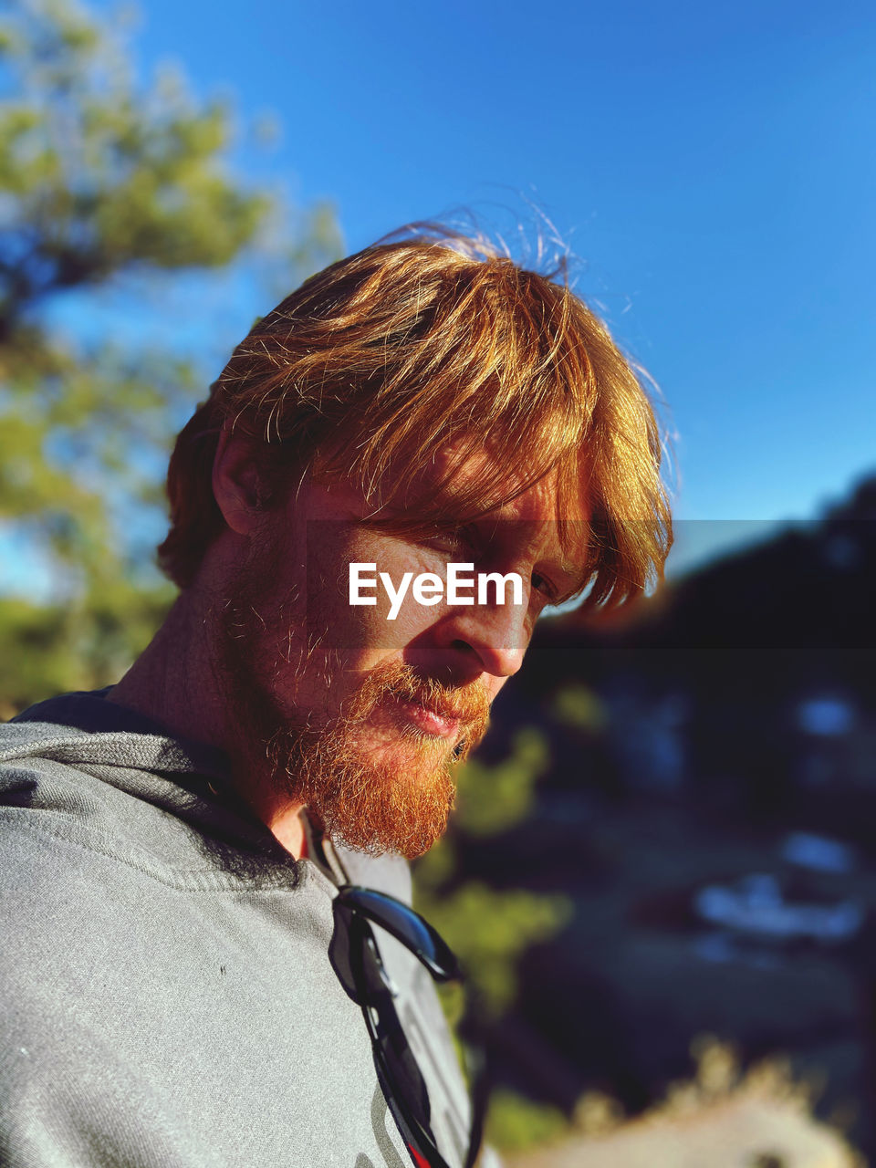 Close-up portrait of man against sky