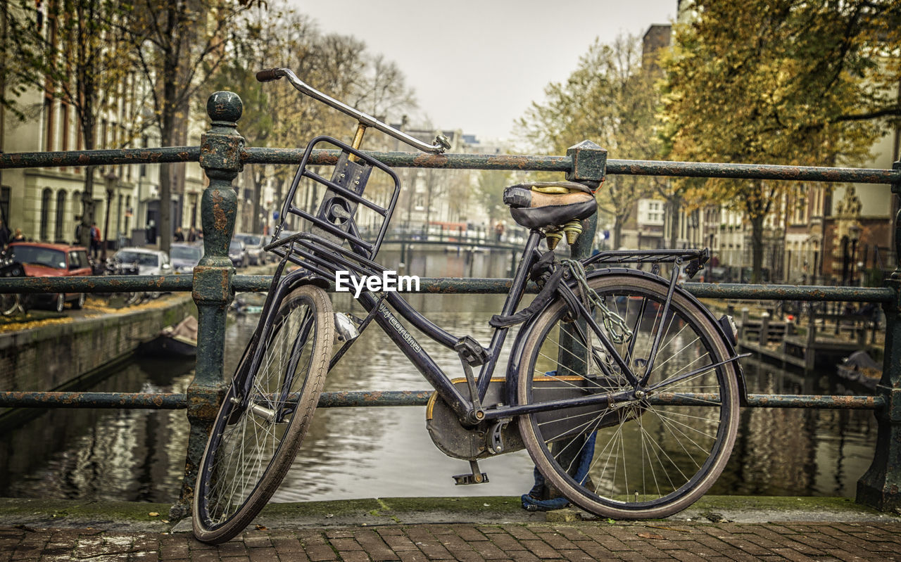 BICYCLE PARKED BY WALL