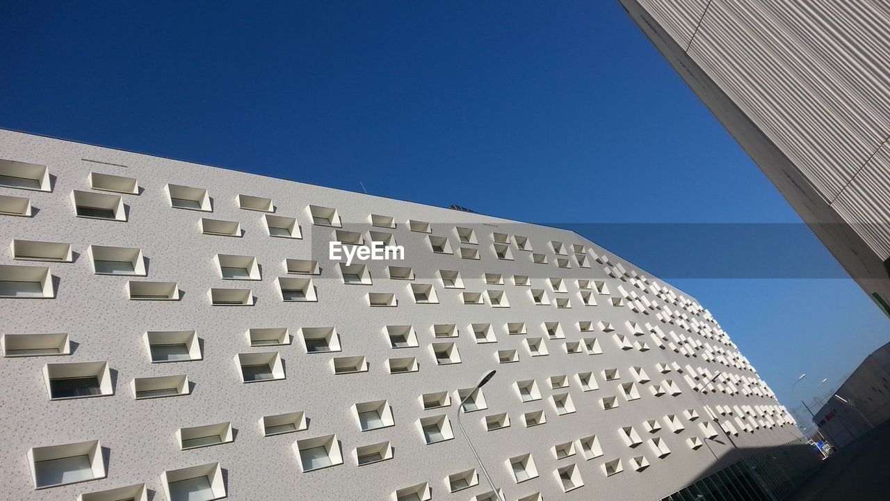 Low angle view of building against clear blue sky