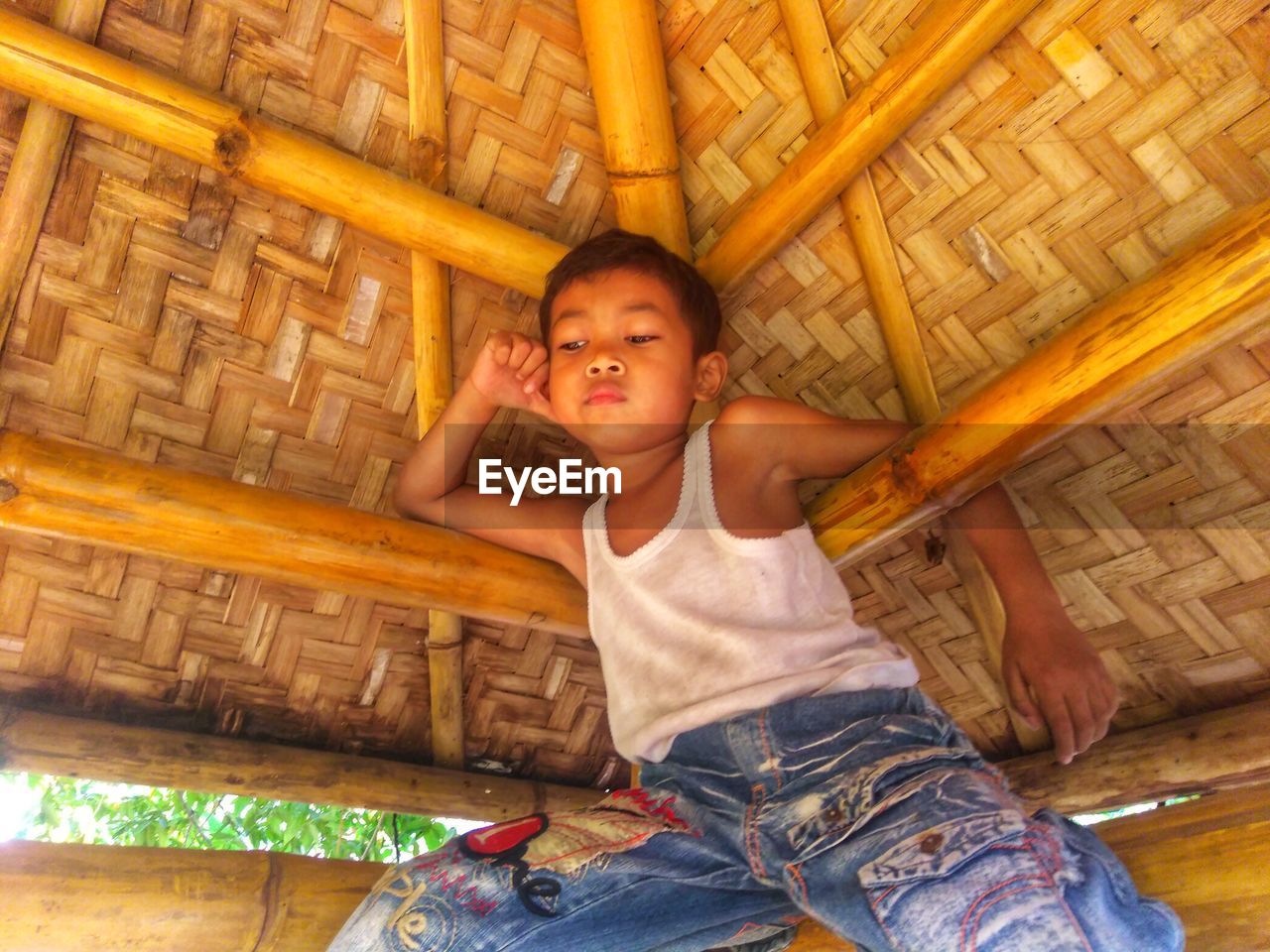 Boy sitting in hut