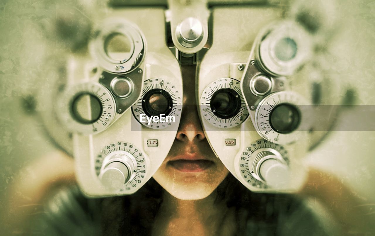 High angle view of eye test equipment over teenage girl