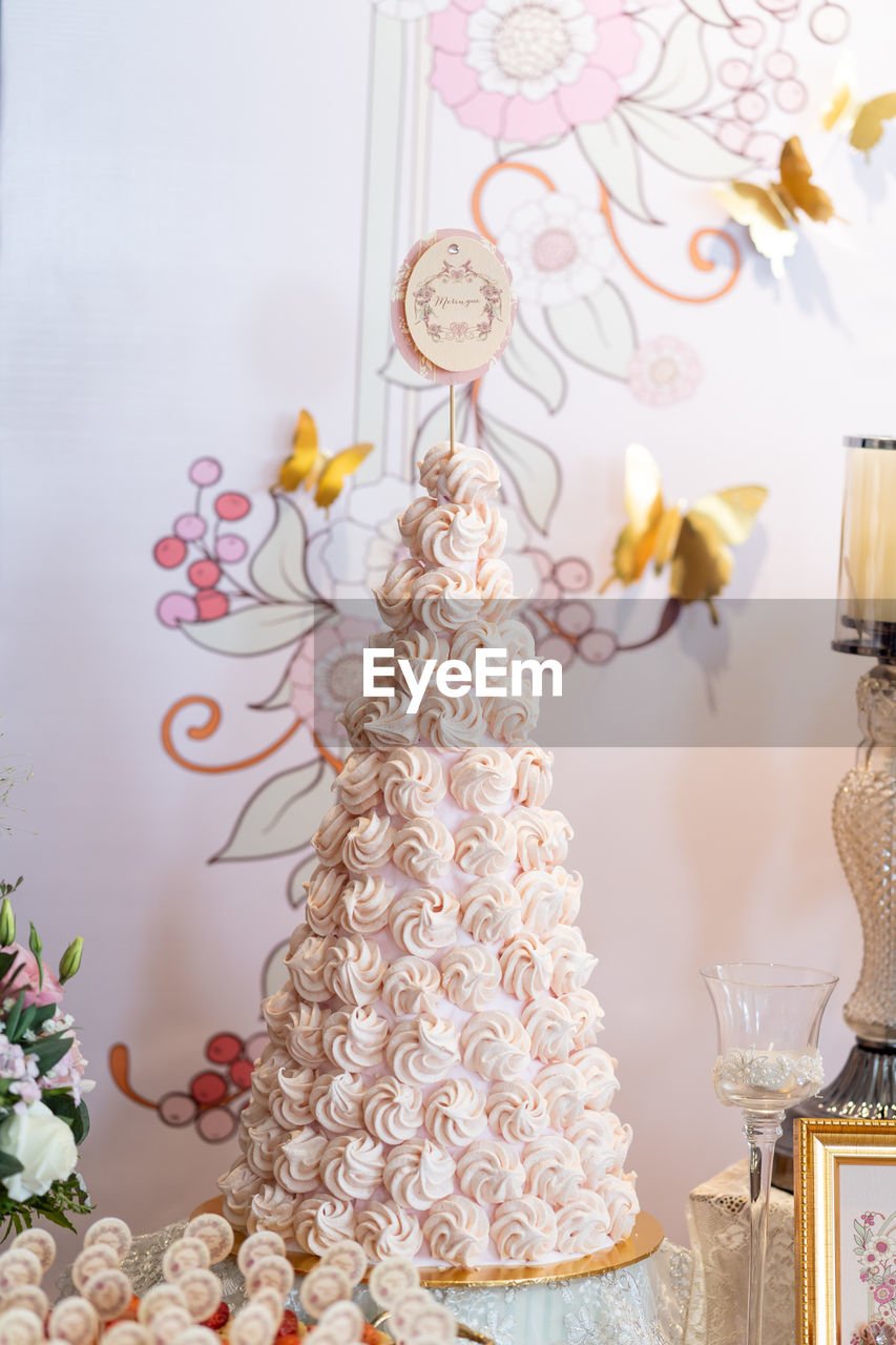 Close-up of cake on table against wall