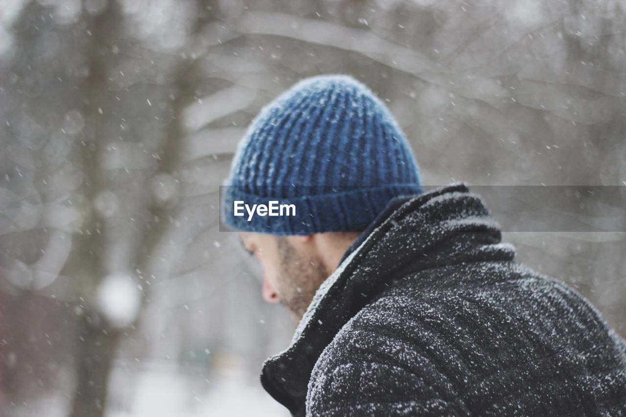 Close-up of man in warm clothing during snowfall