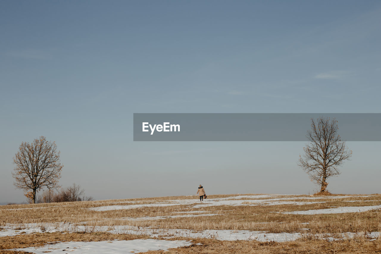 Scenic view of snowy field against sky