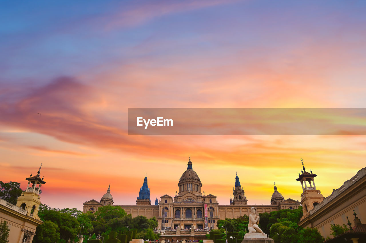 BUILDINGS AGAINST CLOUDY SKY DURING SUNSET