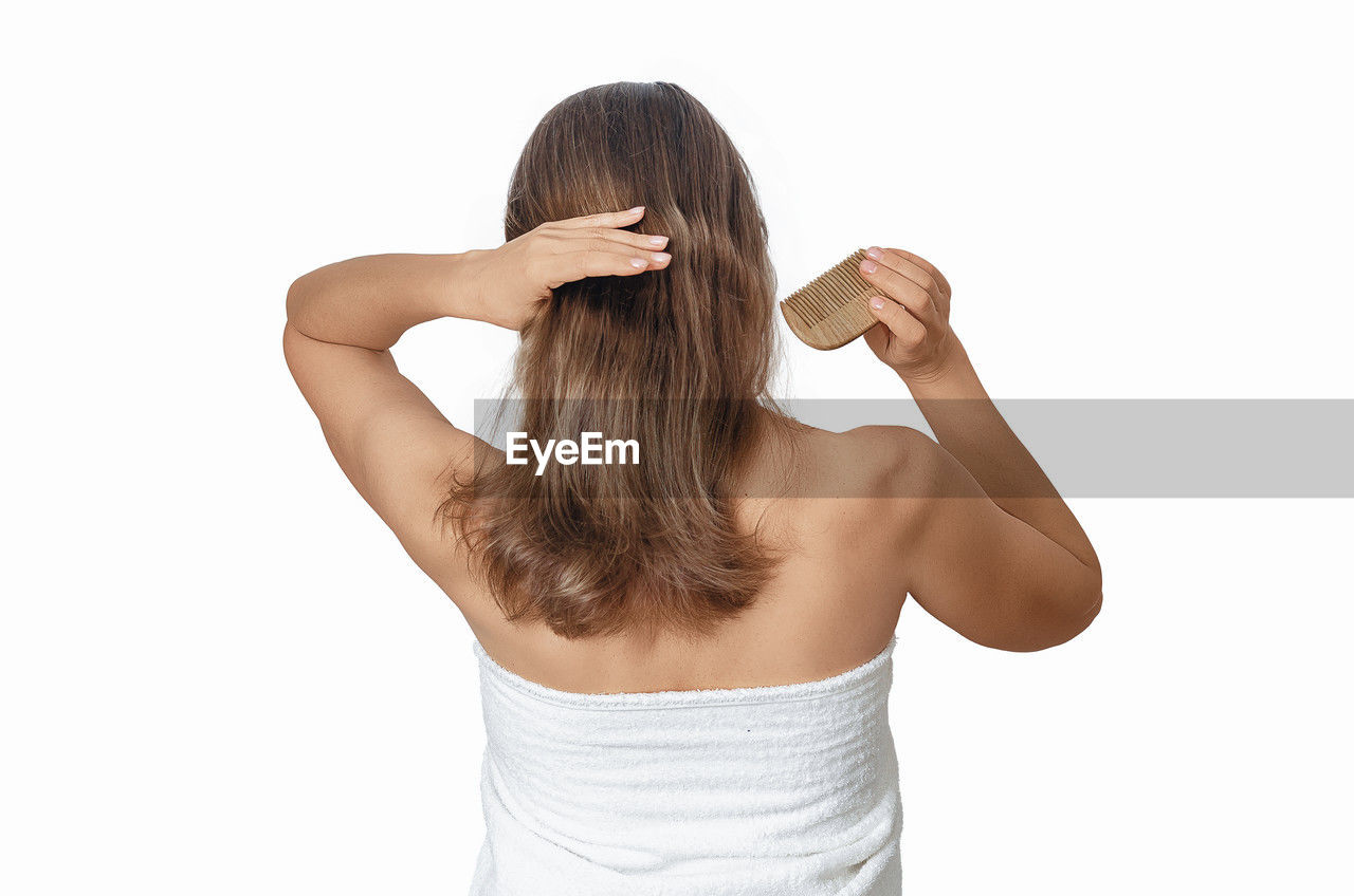 one person, white background, adult, women, rear view, studio shot, arm, cut out, young adult, hairstyle, indoors, hand, waist up, long hair, back, relaxation, portrait, lifestyles, brown hair, copy space, clothing, hand in hair, white, finger, emotion, standing, female, limb, human hair, casual clothing, undergarment