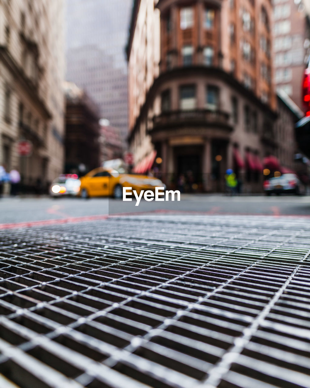 Surface level of metal grate on gutter by road in city