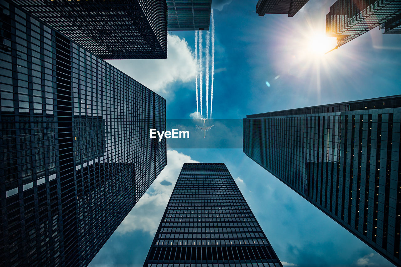 DIRECTLY BELOW SHOT OF MODERN BUILDINGS AGAINST SKY