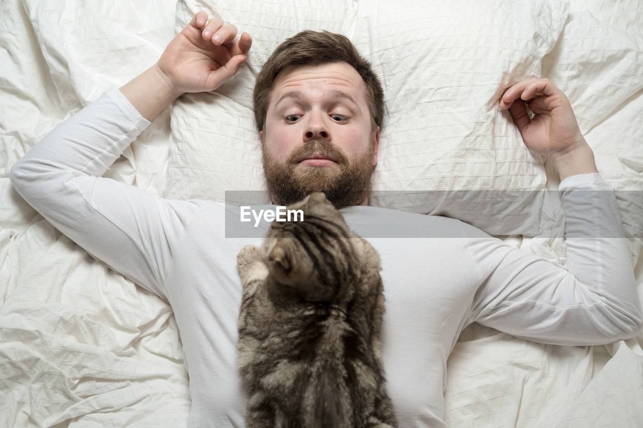 side view of young woman holding cat