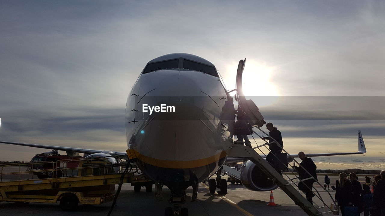 AIRPLANE ON RUNWAY AGAINST SKY