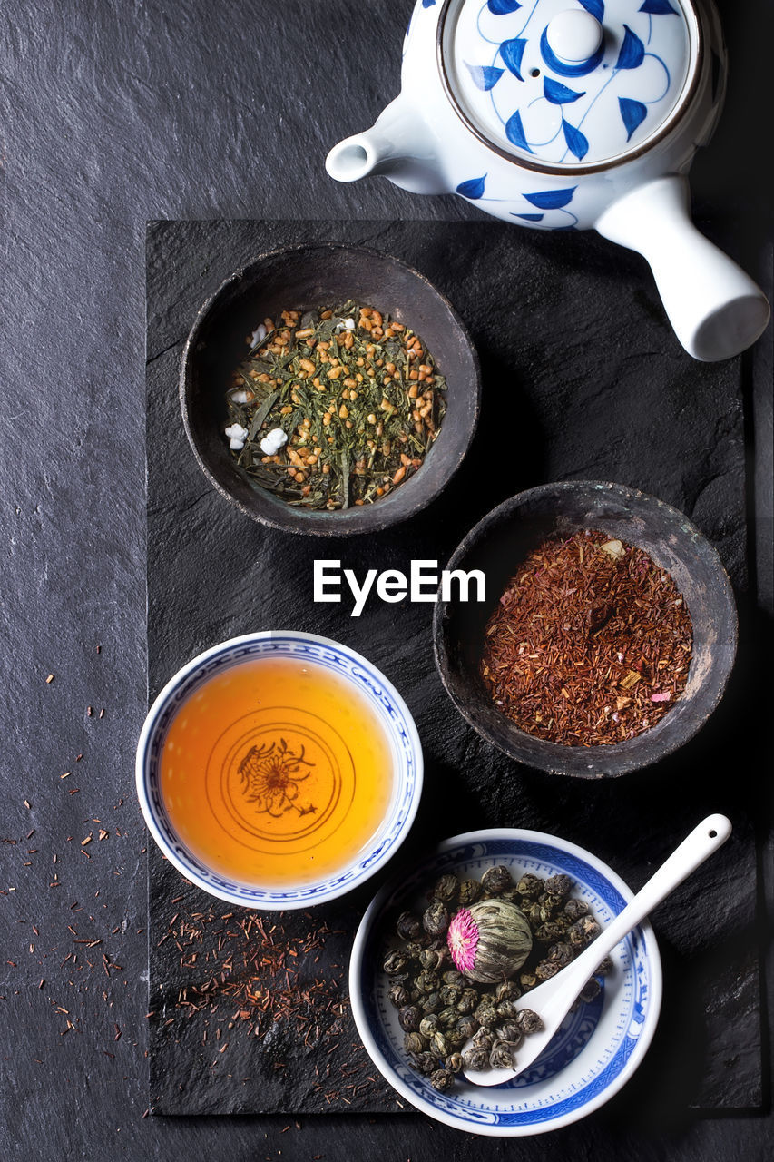 High angle view of various spices on slate