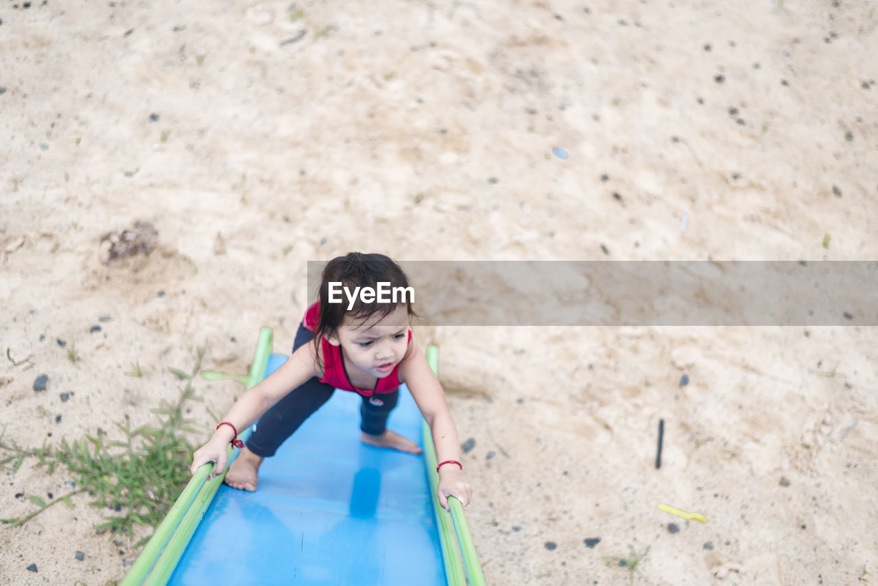 side view of woman sitting on slide