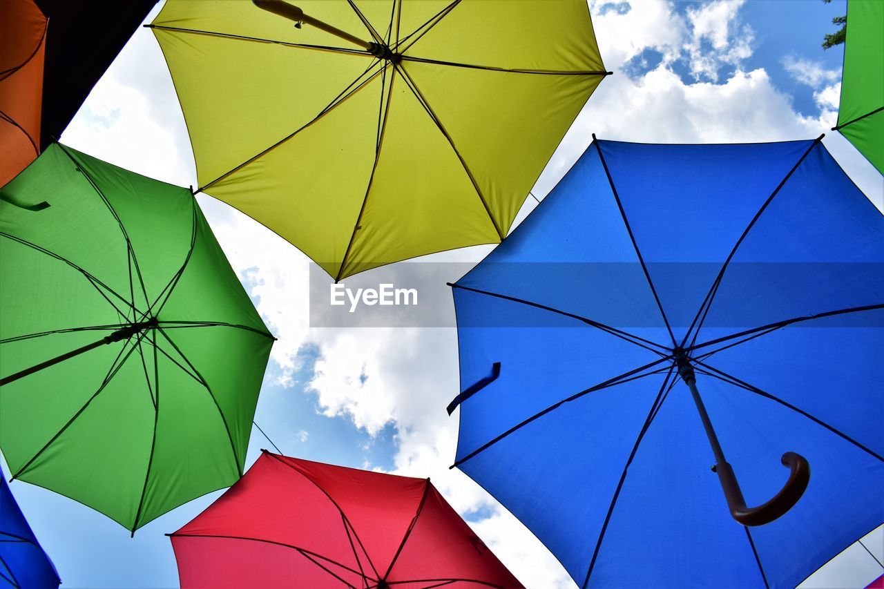 Low angle view of umbrellas against sky