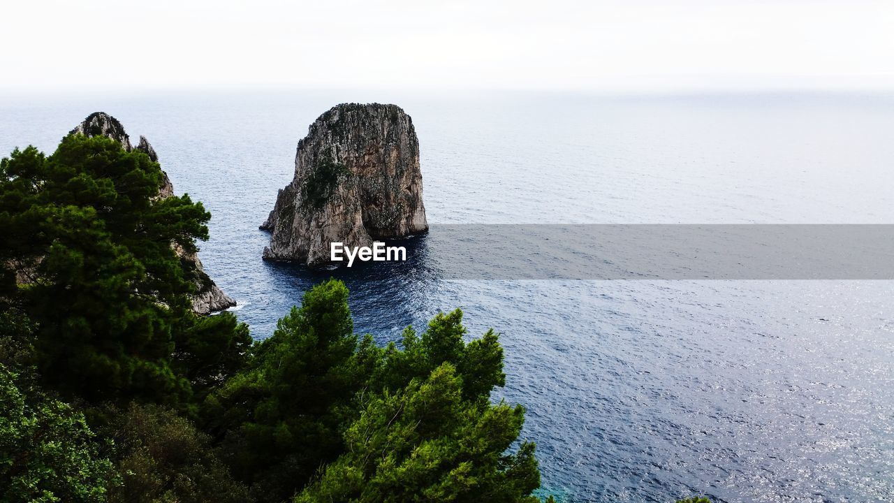 Faraglioni capri - rocks on sea shore against sky