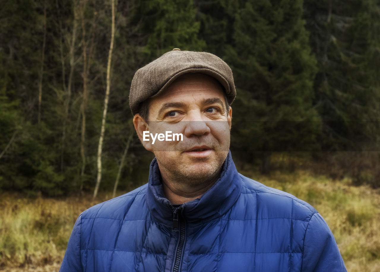 Portrait of man standing in forest